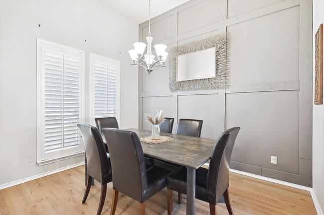 Dining space featuring a chandelier and light wood-type flooring | Image 6