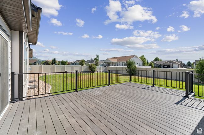 Wooden terrace with a residential view and a fenced backyard | Image 32