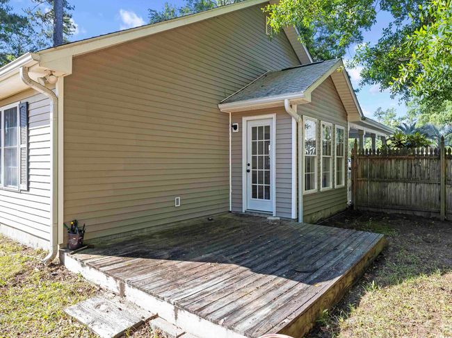 Back of property featuring a wooden deck and fence | Image 27