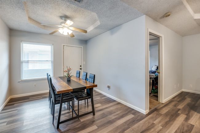 Dining room with a ceiling fan, a textured ceiling, and dark wood finished floors | Image 11
