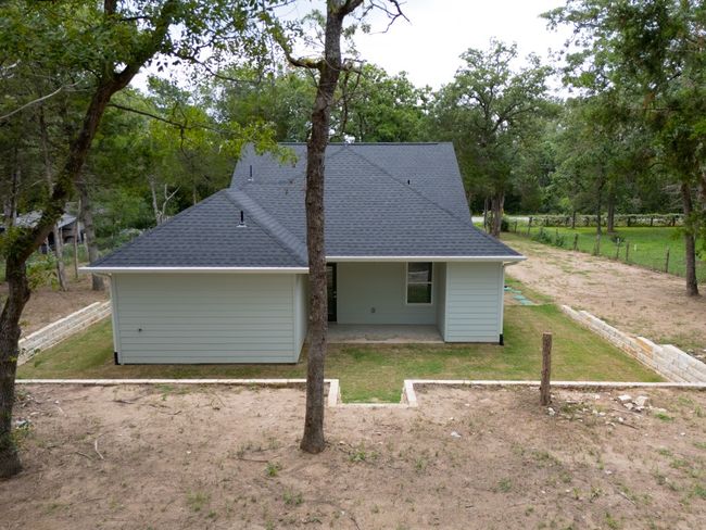 A stunning aerial view of a beautiful home and its expansive backyard—nearly an acre, ready to be yours! | Image 35