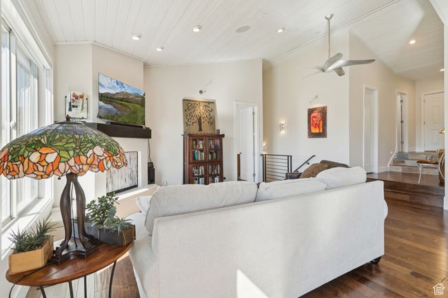 Living area featuring dark wood-style flooring, a ceiling fan, recessed lighting, vaulted ceiling, and wooden ceiling | Image 14