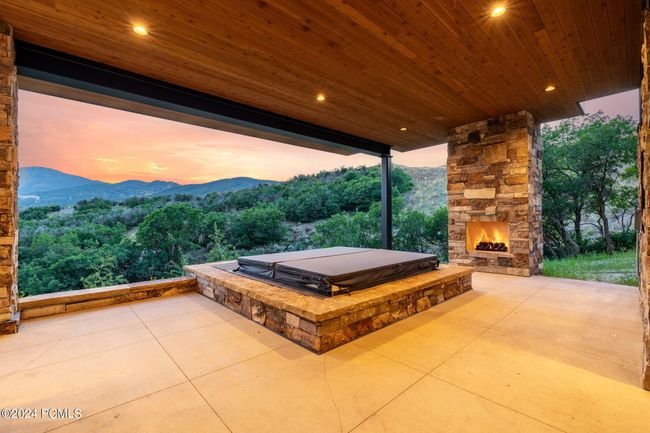 Heated patio with hot tub and fireplace lower level | Image 48