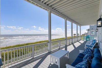 Step onto this expansive back porch featuring high-end low-maintenance TREX decking and soak in panoramic beach views, perfect for enjoying both morning sunrises and stunning sunsets. This is coastal living at its finest, where the breeze is sweet and the views are picturesque. | Image 3