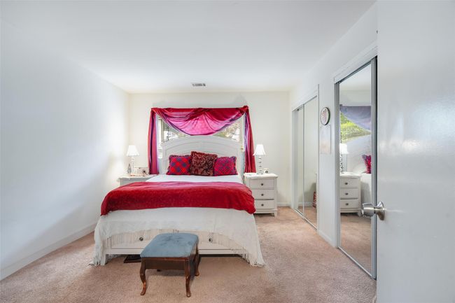 Carpeted bedroom with multiple closets and multiple windows | Image 13