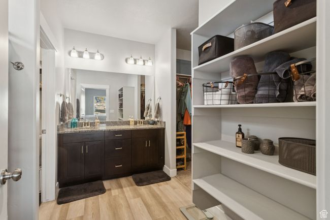 Full bath featuring wood finished floors, vanity, and a walk in closet | Image 25