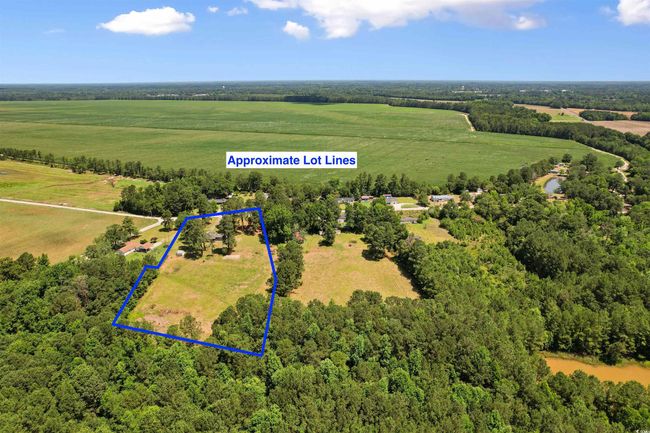 Aerial view of sparsely populated area featuring property parcel outlined | Image 7