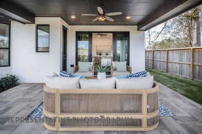 View of patio featuring an outdoor living space and ceiling fan | Image 34