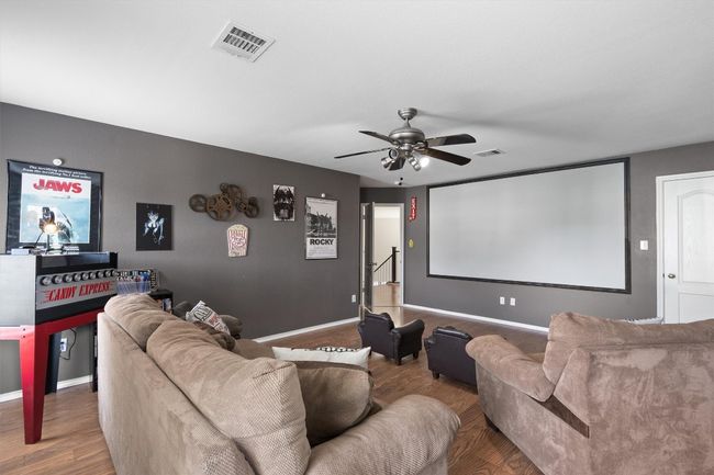 Secondary bedroom currently being used as a media room. Featuring built-in screen, projector and sound system. (which can convey) room also features a walk-in closet. | Image 30