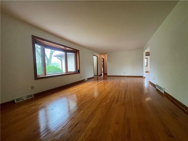 Spare room featuring visible vents, wood finished floors, and baseboards | Image 8
