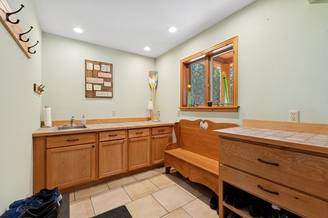 Mud room with tiled floors and a sink | Image 37