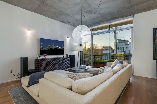 Living room with expansive windows, dark hardwood / wood-style flooring, and an inviting chandelier | Image 8