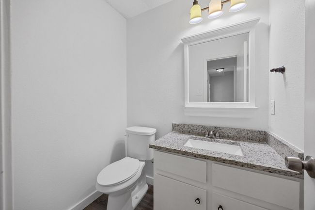 Bathroom with toilet, vanity, wood finished floors, and baseboards | Image 9