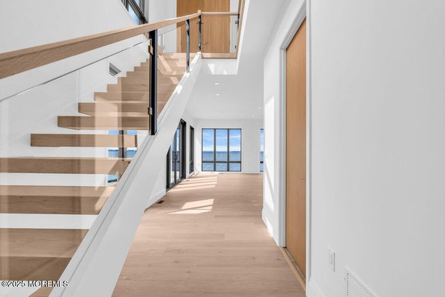 Two story foyer with oversized Anderson Windows looking out to the water. | Image 8