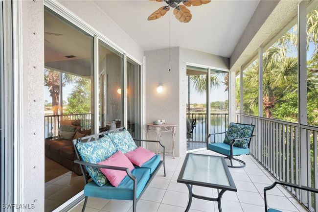 Sunroom / solarium featuring a ceiling fan and a water view | Image 18