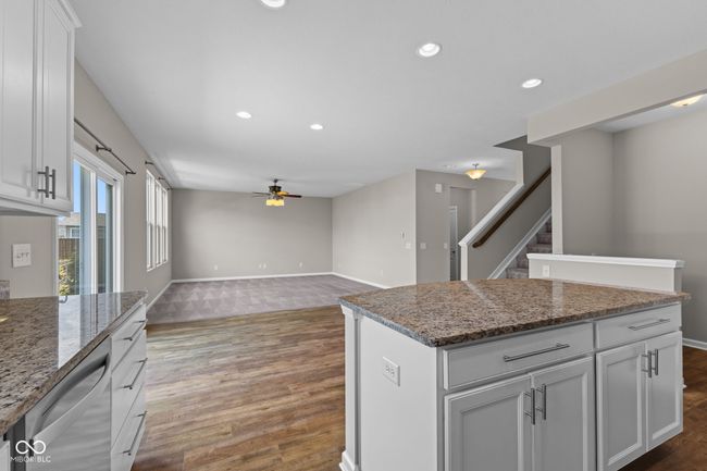 kitchen featuring dishwasher, a ceiling fan, wood finished floors, recessed lighting, and a kitchen island | Image 10