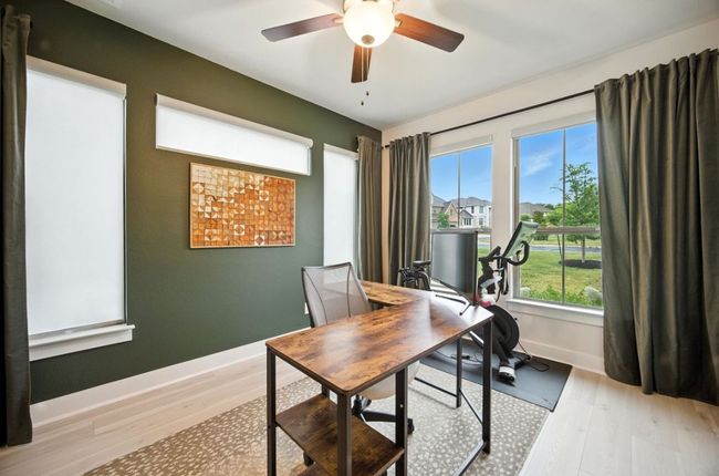 Office space featuring light wood-style floors and ceiling fan | Image 18