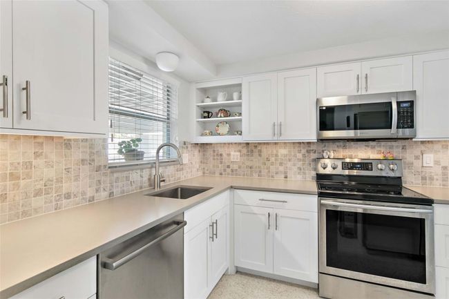 Your kitchen has plentiful solid wood cabinets and quartz counters. | Image 6