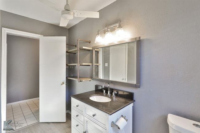 Bathroom featuring ceiling fan, tile patterned flooring, vanity, and toilet | Image 18