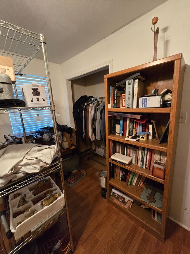 Bedroom with wood finished floors and a closet | Image 25