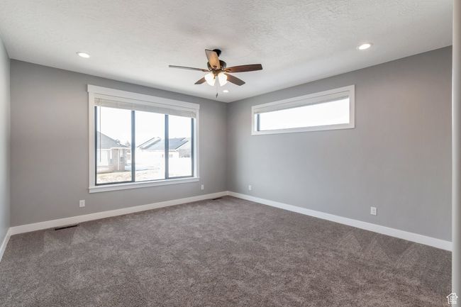 Unfurnished room with ceiling fan, carpet floors, recessed lighting, and a textured ceiling | Image 17