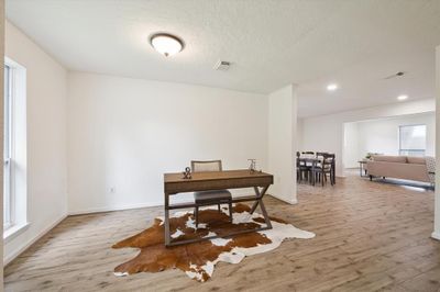 Upon entry, you'll be greeted by a well-lit office space, bathed in natural light for productive workdays ahead. This room can also function as a formal dining or flex space - the possibilities are endless! | Image 3