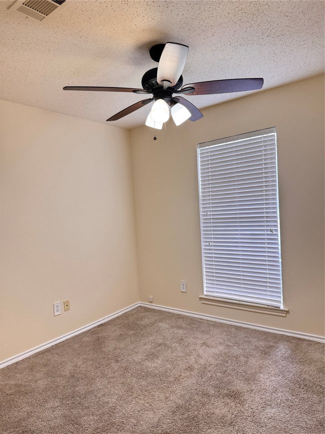 Spare room with ceiling fan, carpet, and baseboards | Image 13