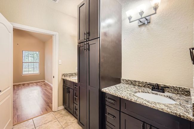 Bathroom with vanity and tile patterned floors | Image 12
