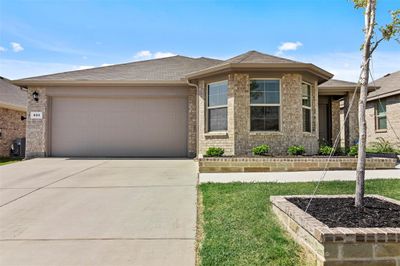 Prairie-style house with a garage and a front yard | Image 1