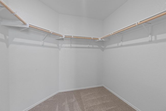 Spacious closet with carpet floors | Image 16