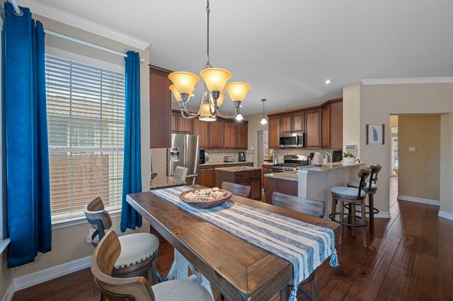 The breakfast dining area is a cozy spot next to the kitchen | Image 15