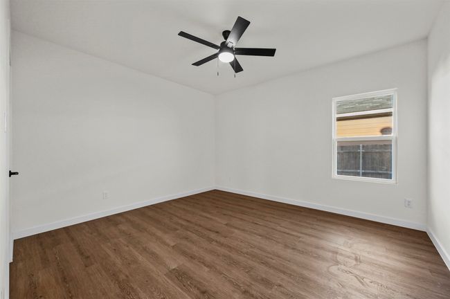 Unfurnished room featuring baseboards, a ceiling fan, and dark wood-type flooring | Image 28