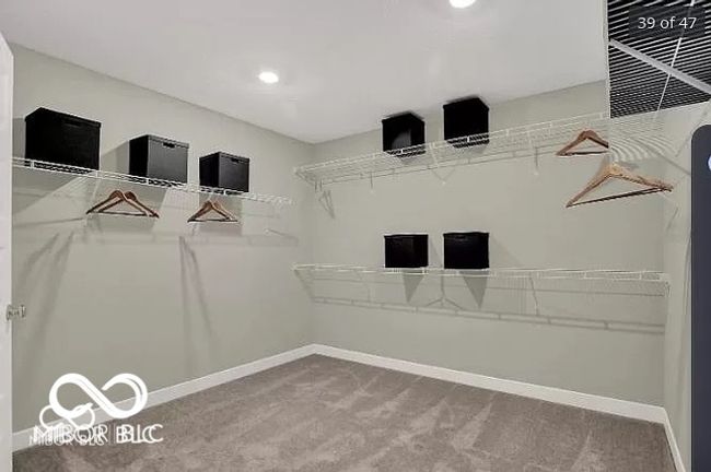 Huge walk in primary closet featuring carpeted floors | Image 15