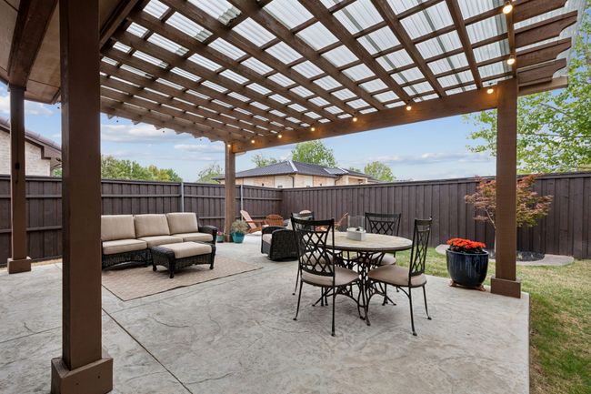 View of patio featuring a pergola, outdoor dining area, a fenced backyard, and an outdoor living space | Image 37