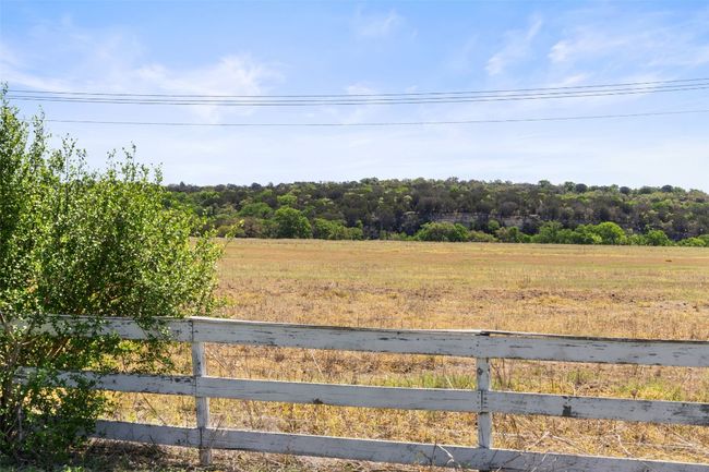 View of yard featuring a rural view, a view of trees, and fence | Image 14