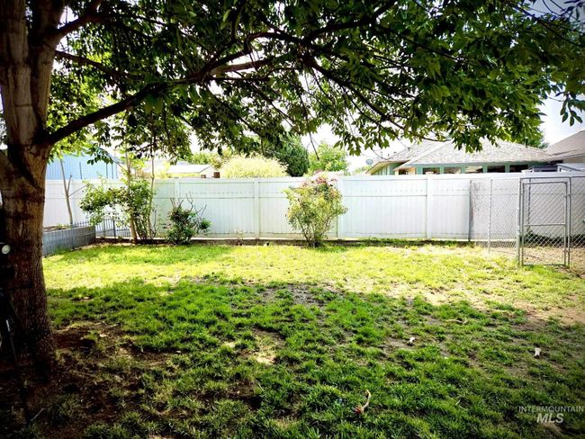 View of fenced backyard | Image 11