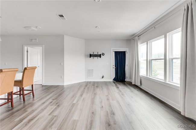 Unfurnished living room featuring light wood-type flooring and baseboards | Image 35