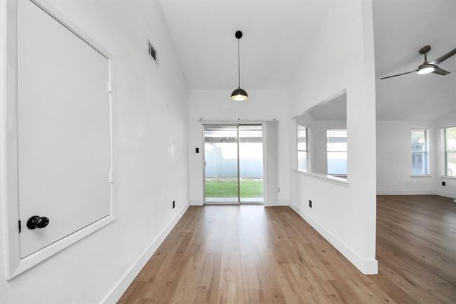 Dining room located between kitchen and patio. | Image 10