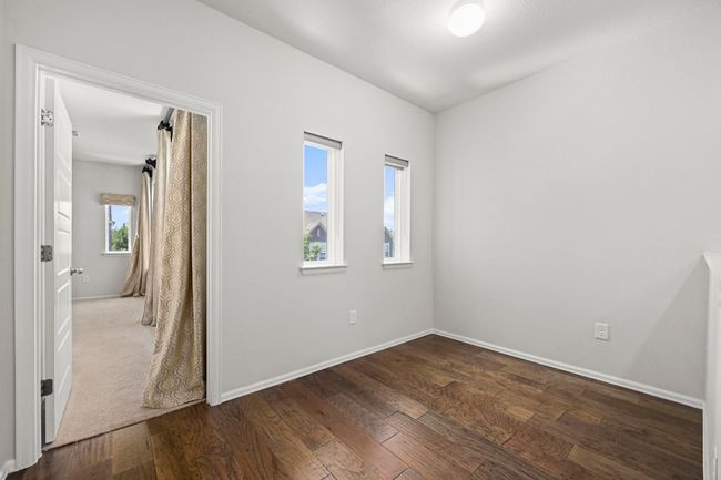 Unfurnished room featuring dark wood-style flooring and baseboards | Image 21