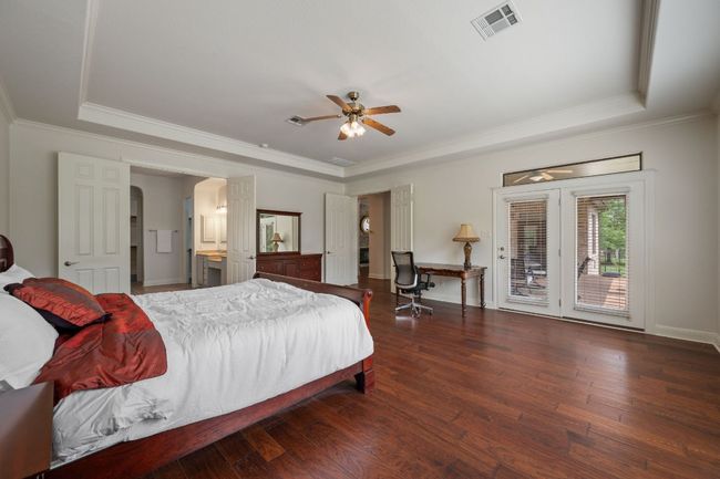 Bedroom featuring visible vents, a raised ceiling, access to outside, and hardwood / wood-style flooring | Image 21