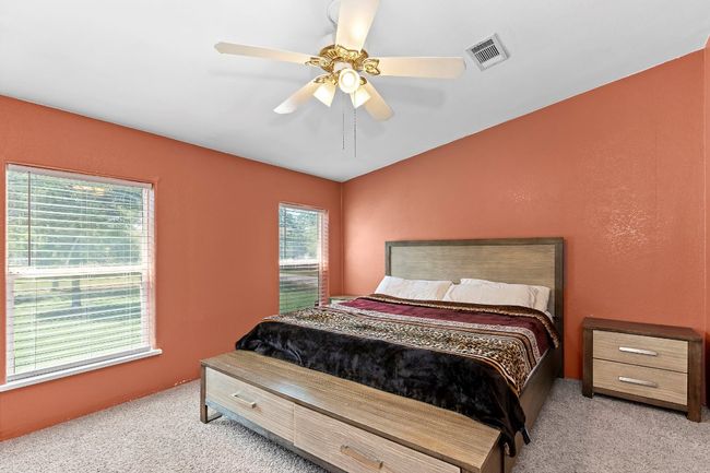 Bedroom with carpet, a ceiling fan, and lofted ceiling | Image 13
