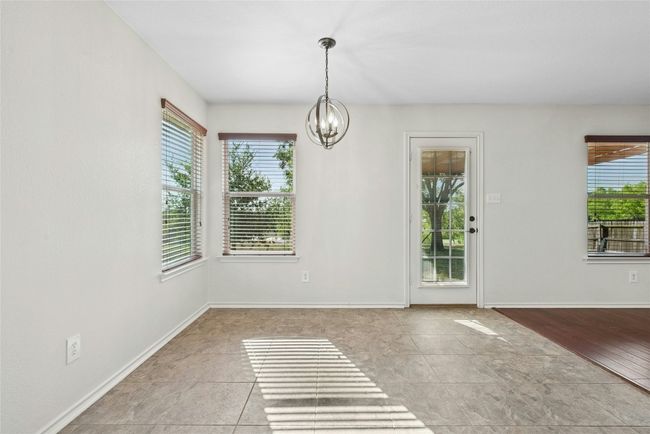 Unfurnished dining area with plenty of natural light and a chandelier | Image 7