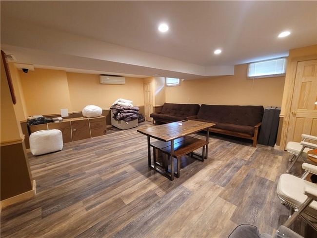 Living room featuring a wall unit AC and hardwood / wood-style floors | Image 20
