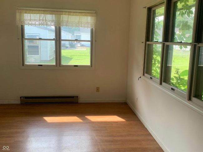 Sunroom gives you extra living space. baseboard heating unit, a ceiling fan, and vinyl finished floors | Image 6
