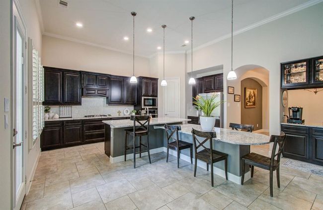 Elegant kitchen with under mount lighting. | Image 11