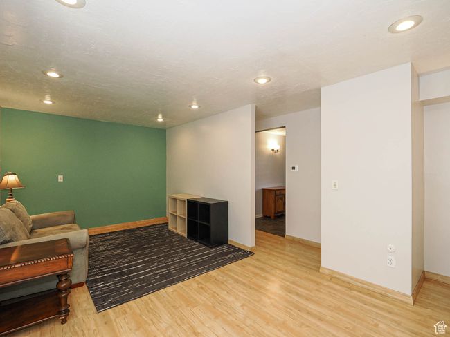 Living area with light wood-type flooring, baseboards, and recessed lighting | Image 14