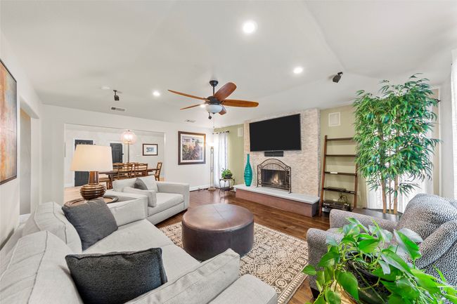 Living area with ceiling fan, visible vents, baseboards, recessed lighting, and wood finished floors | Image 11
