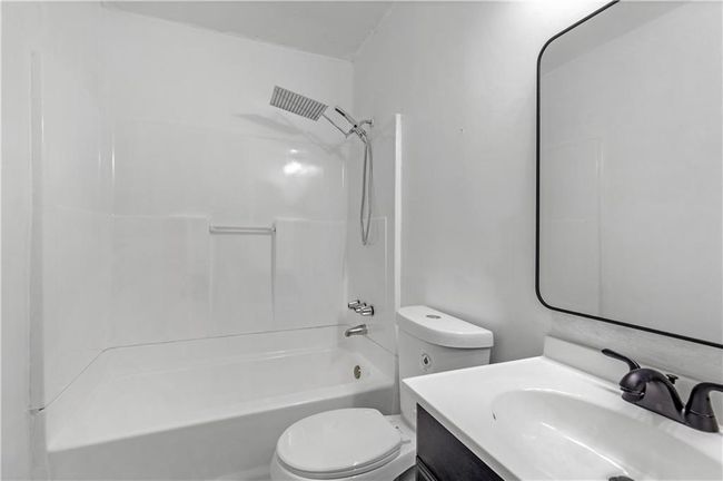 Full bath featuring toilet, vanity, and shower / tub combination | Image 16