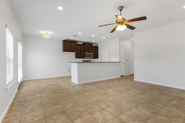 Unfurnished living room featuring ceiling fan, healthy amount of natural light, recessed lighting, and light tile patterned floors | Image 8