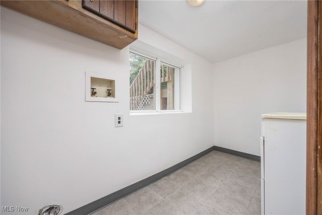 Laundry room with cabinet space, baseboards, and washer hookup | Image 23
